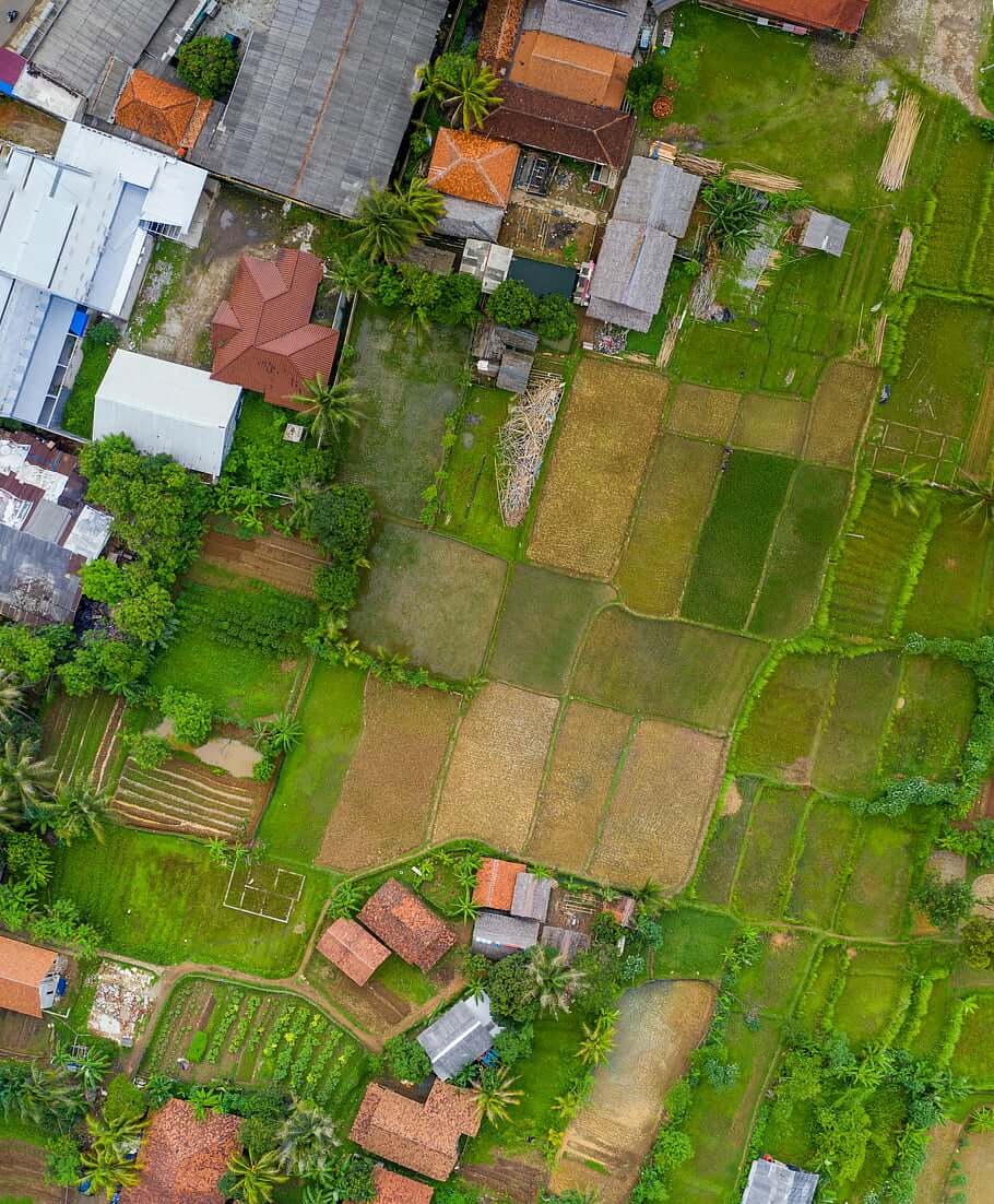 Aerial view of patchwork farmland and scattered houses.
