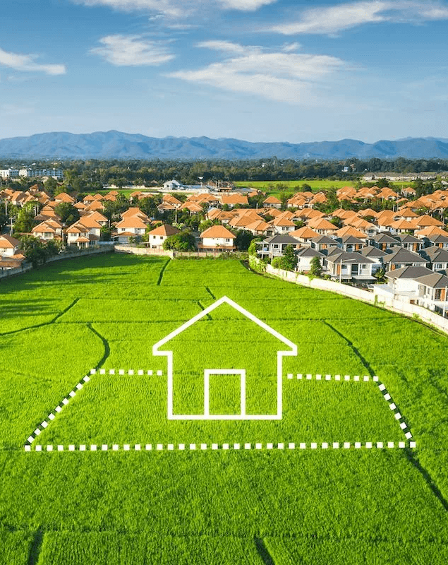 A green plot of land marked for future housing development.